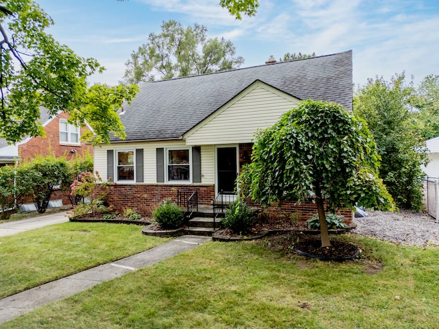4423 Groveland Ave, Royal Oak, MI 48073 - view of front of property featuring a shingled roof, a front yard, fence, and brick siding