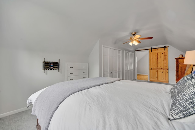 4423 Groveland Ave, Royal Oak, MI 48073 - carpeted bedroom with baseboards, two closets, a barn door, a ceiling fan, and lofted ceiling