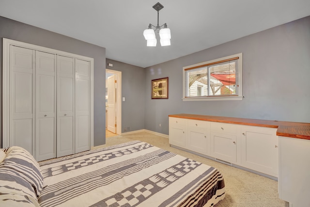 4423 Groveland Ave, Royal Oak, MI 48073 - bedroom with a closet, light colored carpet, a notable chandelier, and baseboards
