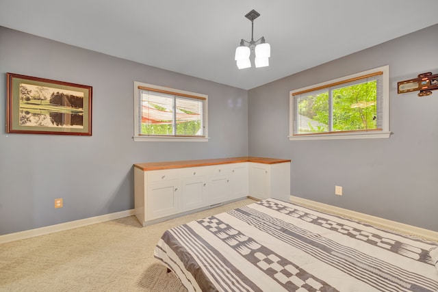 4423 Groveland Ave, Royal Oak, MI 48073 - bedroom with baseboards, multiple windows, an inviting chandelier, and light carpet