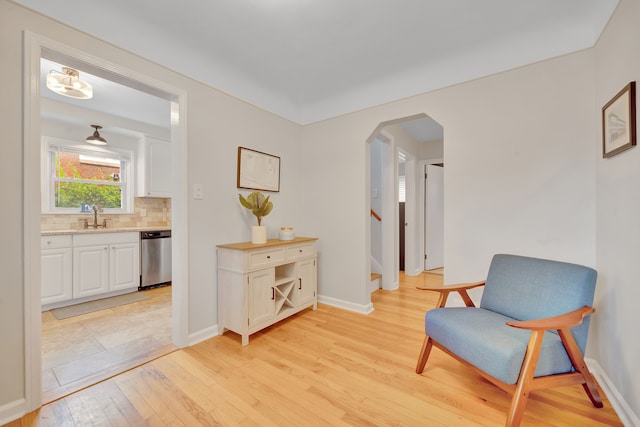 4423 Groveland Ave, Royal Oak, MI 48073 - sitting room featuring light wood-type flooring, baseboards, stairway, and arched walkways