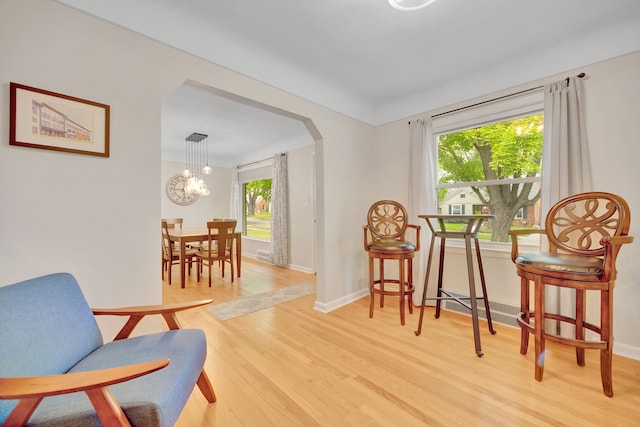 4423 Groveland Ave, Royal Oak, MI 48073 - sitting room with a chandelier, arched walkways, baseboards, and wood finished floors