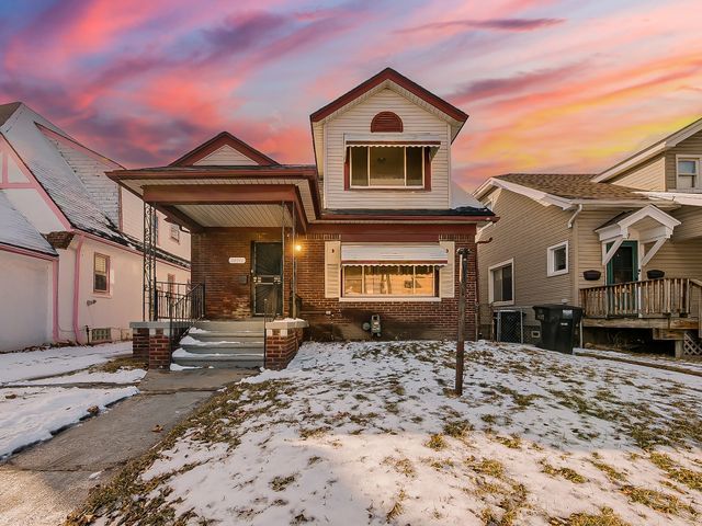 14011 Roselawn St, Detroit, MI 48238 - view of front of home with brick siding, a porch, and central AC
