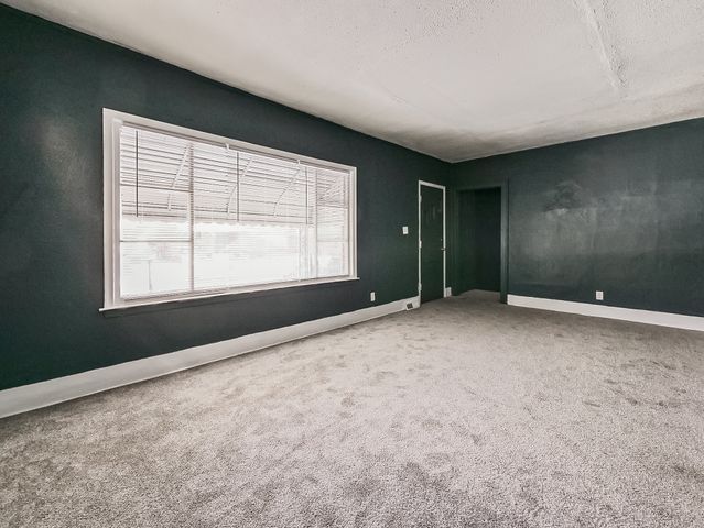 14011 Roselawn St, Detroit, MI 48238 - carpeted empty room with baseboards