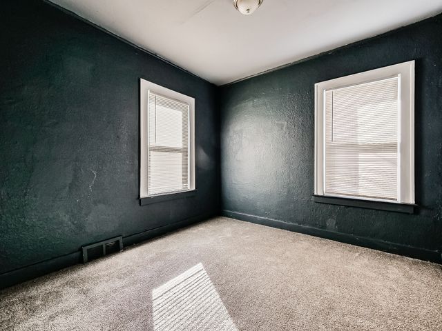 14011 Roselawn St, Detroit, MI 48238 - carpeted spare room with a textured wall and visible vents