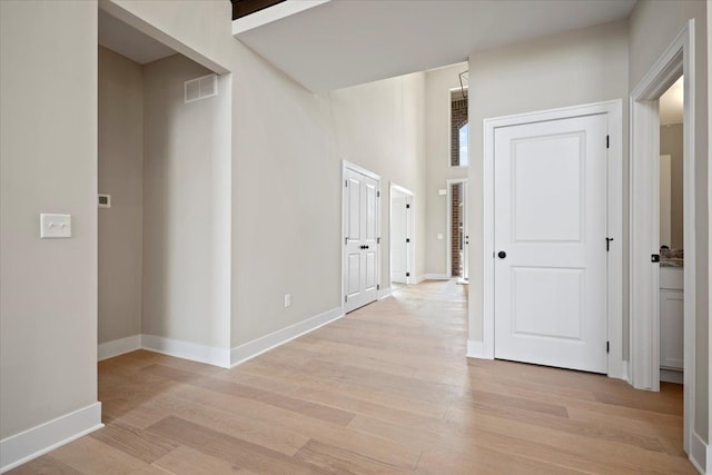 24599 Brookshire Dr, Macomb, MI 48042 - hallway with baseboards, light wood finished floors, and visible vents