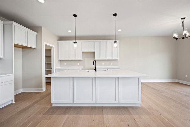 24599 Brookshire Dr, Macomb, MI 48042 - kitchen with light countertops, baseboards, a sink, and white cabinets
