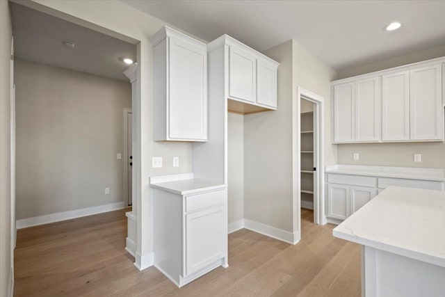 24599 Brookshire Dr, Macomb, MI 48042 - kitchen with white cabinets, baseboards, and light wood-type flooring