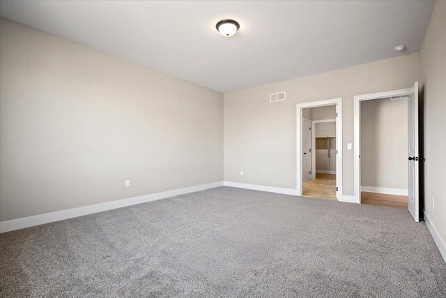 24599 Brookshire Dr, Macomb, MI 48042 - unfurnished bedroom with baseboards, visible vents, and light carpet