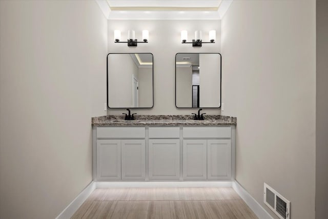 24599 Brookshire Dr, Macomb, MI 48042 - full bath with visible vents, double vanity, baseboards, and a sink