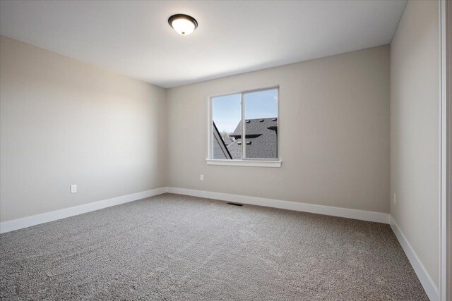 24599 Brookshire Dr, Macomb, MI 48042 - empty room featuring carpet floors, baseboards, and visible vents