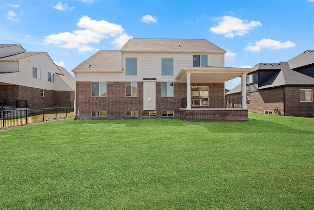 24599 Brookshire Dr, Macomb, MI 48042 - back of property with a lawn, fence, and brick siding