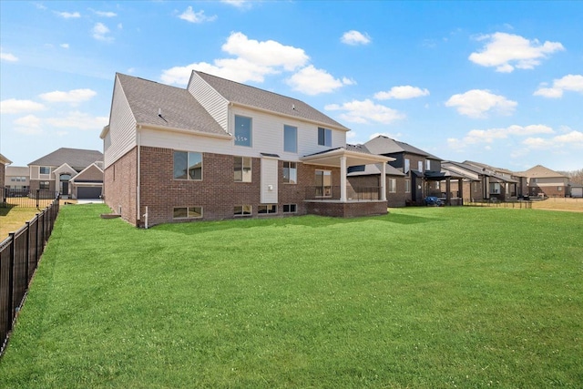 24599 Brookshire Dr, Macomb, MI 48042 - rear view of house with a yard, brick siding, fence, and a residential view