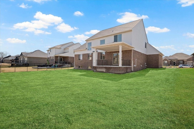 24599 Brookshire Dr, Macomb, MI 48042 - back of house with a yard, brick siding, fence, and a residential view
