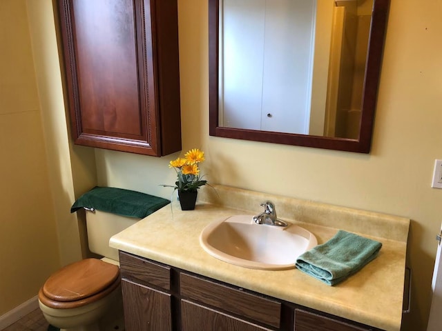 half bathroom featuring toilet and vanity