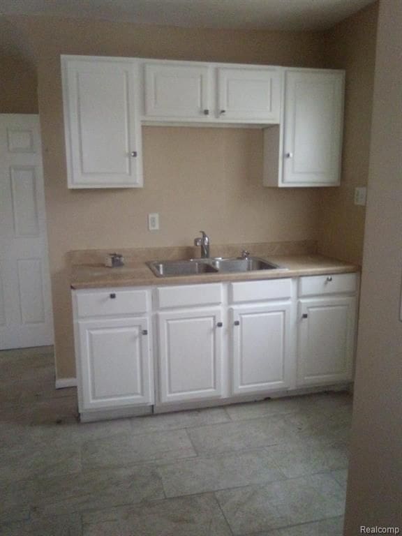 14595 Terry St, Detroit, MI 48227 - kitchen featuring white cabinetry, light countertops, and a sink