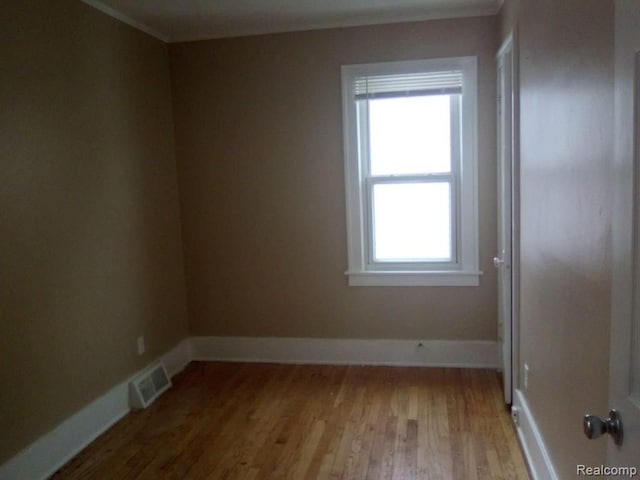 14595 Terry St, Detroit, MI 48227 - unfurnished room with baseboards, visible vents, and wood finished floors