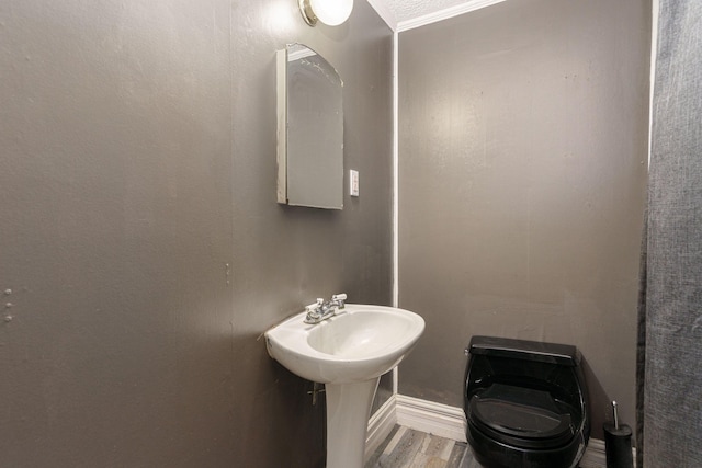 4725 Hickory Dr, Highland, MI 48356 - half bathroom with toilet and wood finished floors