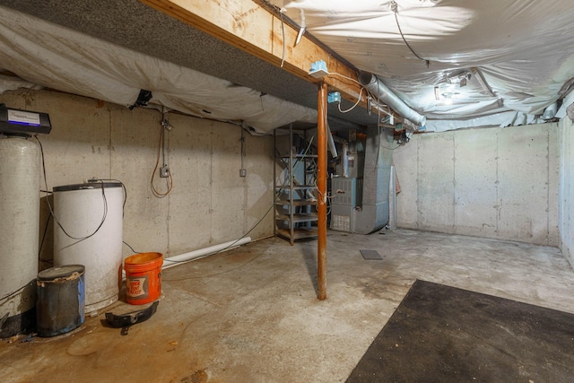 4725 Hickory Dr, Highland, MI 48356 - unfinished below grade area featuring heating unit and a water softener system