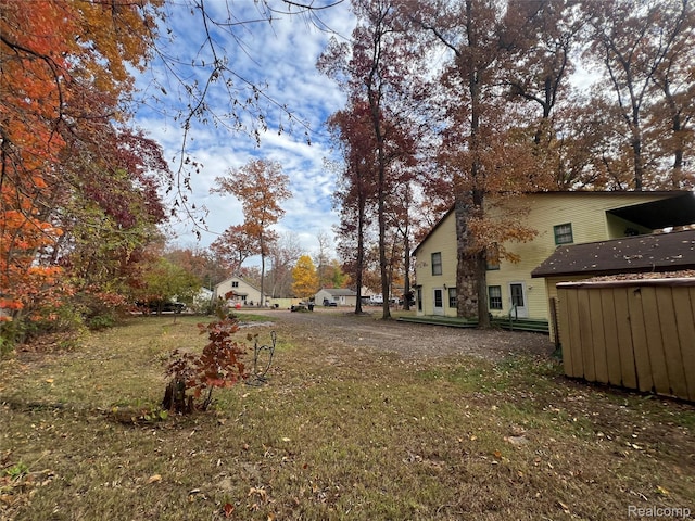 4725 Hickory Dr, Highland, MI 48356 - view of grassy yard featuring a shed