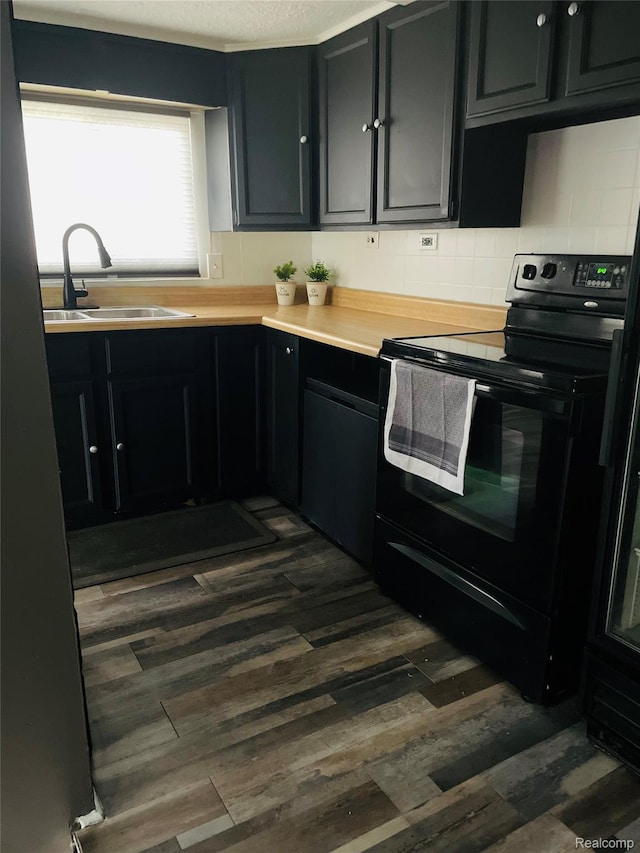 4725 Hickory Dr, Highland, MI 48356 - kitchen featuring black electric range, dark cabinets, dark wood-style flooring, and light countertops