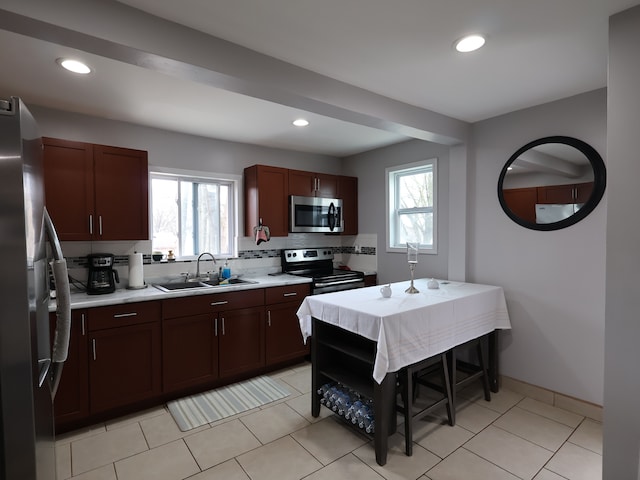 81 E Fairmount Ave, Pontiac, MI 48340 - kitchen featuring light countertops, appliances with stainless steel finishes, a sink, and a healthy amount of sunlight