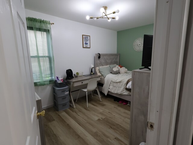 81 E Fairmount Ave, Pontiac, MI 48340 - bedroom with light wood finished floors and a notable chandelier