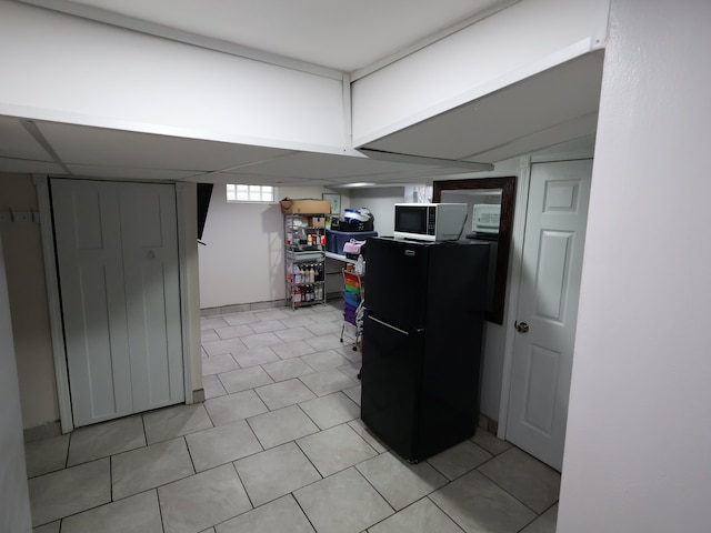 81 E Fairmount Ave, Pontiac, MI 48340 - basement featuring freestanding refrigerator and light tile patterned flooring