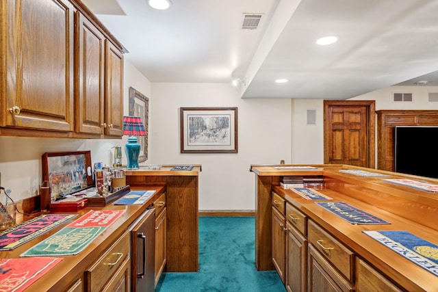 6242 131st St, Saugatuck, MI 49453 - kitchen featuring wooden counters, recessed lighting, dark colored carpet, and visible vents