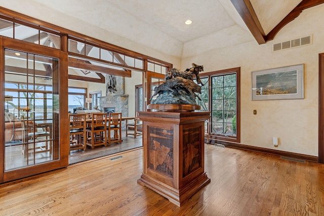 6242 131st St, Saugatuck, MI 49453 - interior space with wood finished floors, lofted ceiling with beams, baseboards, and visible vents