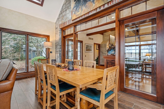 6242 131st St, Saugatuck, MI 49453 - dining room featuring wood finish floors and high vaulted ceiling