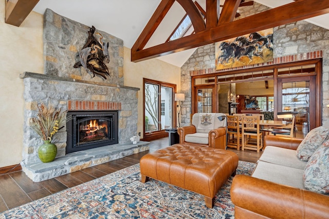 6242 131st St, Saugatuck, MI 49453 - living area featuring high vaulted ceiling, wood finished floors, beam ceiling, and a stone fireplace