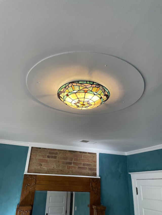 interior details with ornamental molding and visible vents