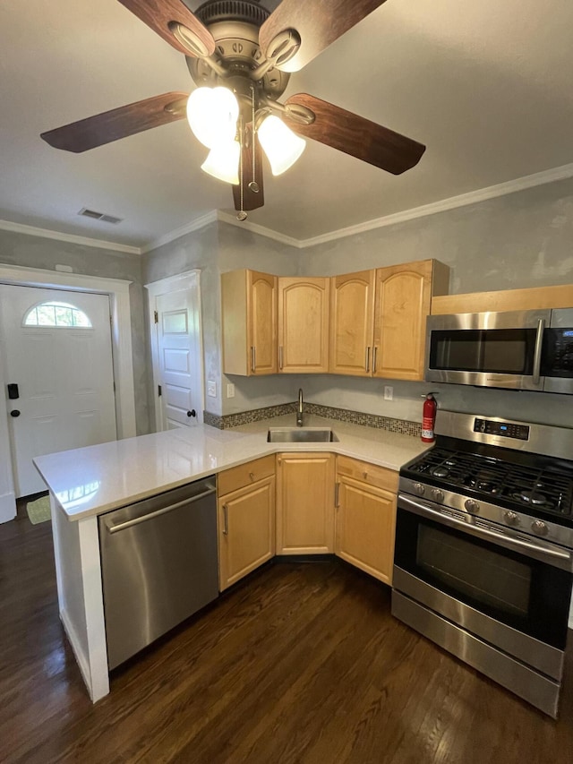 kitchen with light countertops, a sink, stainless steel appliances, light brown cabinets, and visible vents