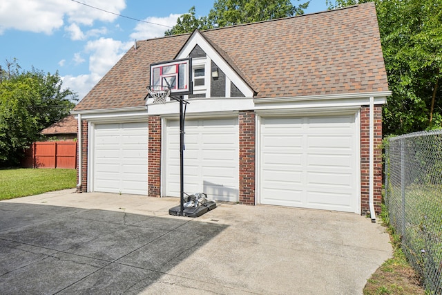 detached garage featuring fence