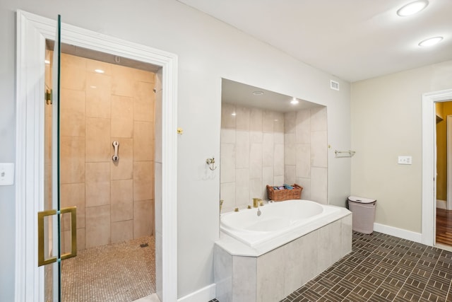 full bath featuring a tile shower, a garden tub, baseboards, and recessed lighting