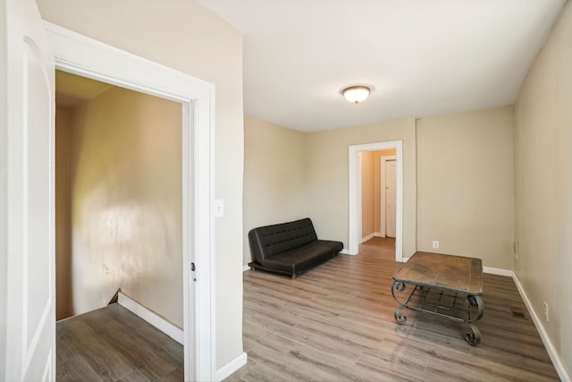 unfurnished room with wood finished floors and baseboards