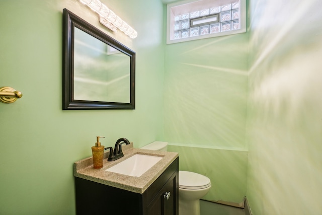 half bathroom with toilet and vanity
