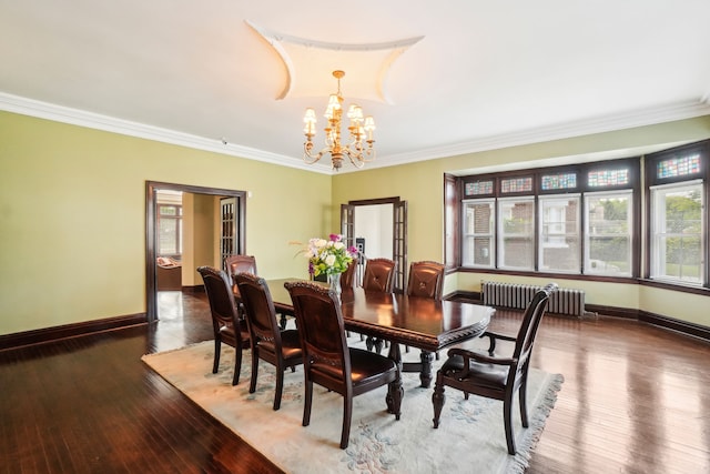 dining room with radiator, ornamental molding, a chandelier, baseboards, and hardwood / wood-style floors
