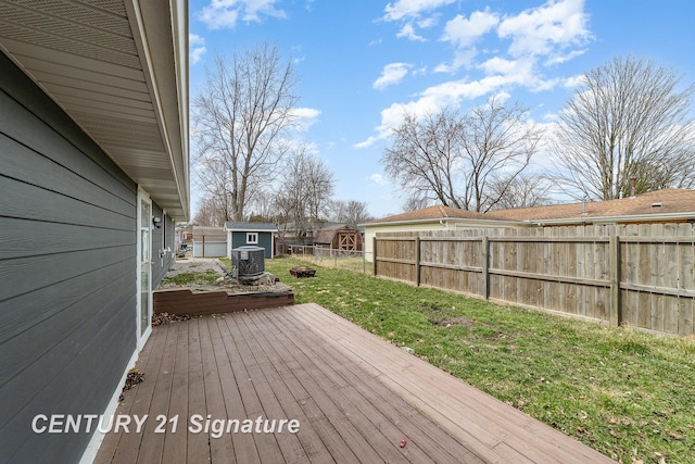 5024 Kencliff Dr, Saginaw, MI 48638 - wooden deck featuring central air condition unit, an outdoor structure, a storage shed, fence private yard, and a lawn