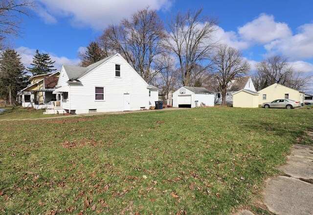 1406 Lincoln Ave, Flint, MI 48507 - view of side of home featuring a yard, an outdoor structure, and a garage