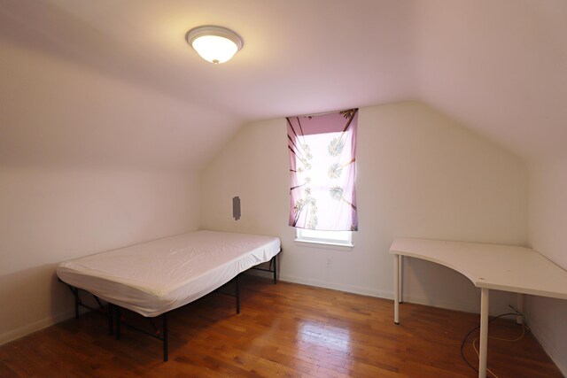 1406 Lincoln Ave, Flint, MI 48507 - bedroom featuring baseboards, vaulted ceiling, and wood finished floors