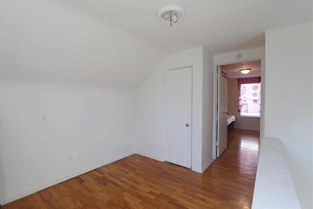 1406 Lincoln Ave, Flint, MI 48507 - additional living space with wood finished floors, baseboards, and vaulted ceiling