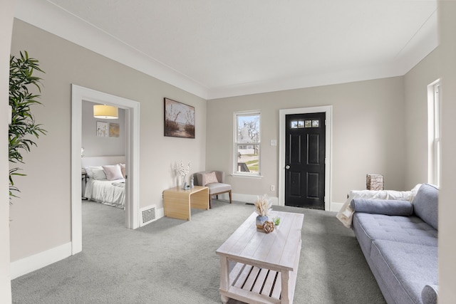 carpeted living room featuring baseboards and visible vents