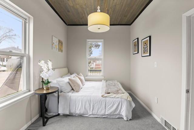 bedroom with baseboards, visible vents, wood ceiling, and carpet flooring