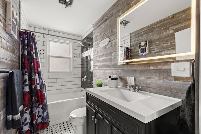 full bathroom with toilet, wood walls, vanity, and shower / bath combo