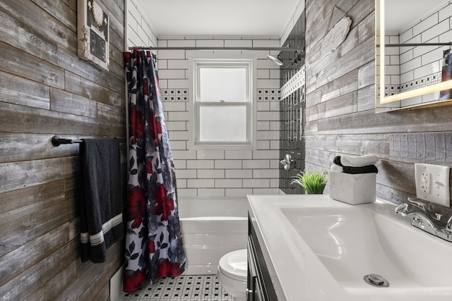 bathroom featuring toilet, wood walls, vanity, and shower / bathtub combination with curtain