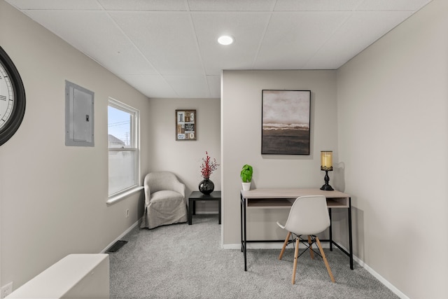 home office featuring electric panel, baseboards, visible vents, and carpet