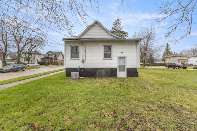 back of property featuring a yard