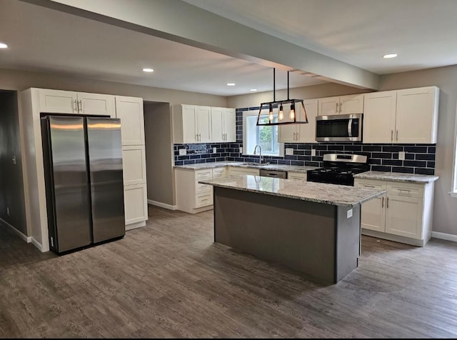 kitchen featuring stainless steel appliances, dark wood-style floors, baseboards, and white cabinetry